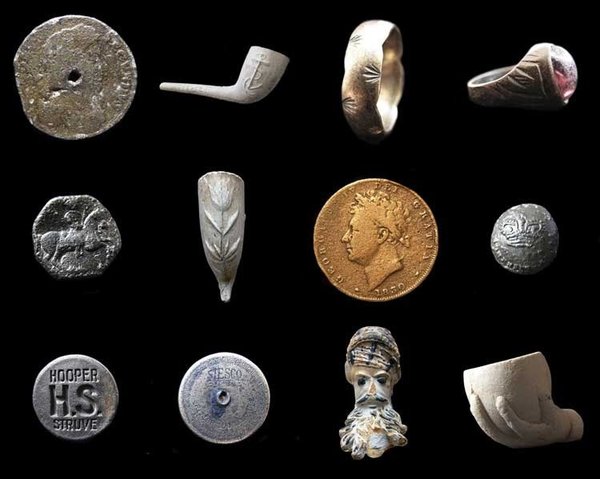 Found objects from the Thames. Top row: a 1687 tin halfpenny, a Victorian clay pipe, a gold ring, a Victorian ring. Middle row: a decorated medieval button, a Victorian clay pipe, an 1830 George IV farthing, a Georgian military button. Bottom row: a Hooper Brewery stopper, a sailor's bag lock, a French Jacob pipe bowl and a child's toy clay pipe bowl. Note: objects not to scale